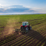 Tractor cultivating field at spring,aerial view