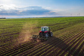 Tractor cultivating field at spring,aerial view